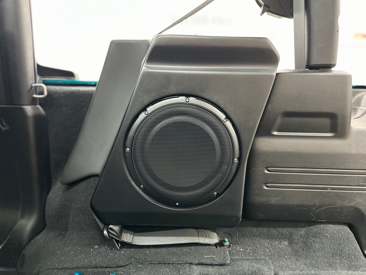 Loaded subwoofer enclosure installed in a Jeep Wrangler JL with non-Alpine audio